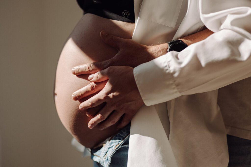Sesja ciążowa – dłonie na brzuchu